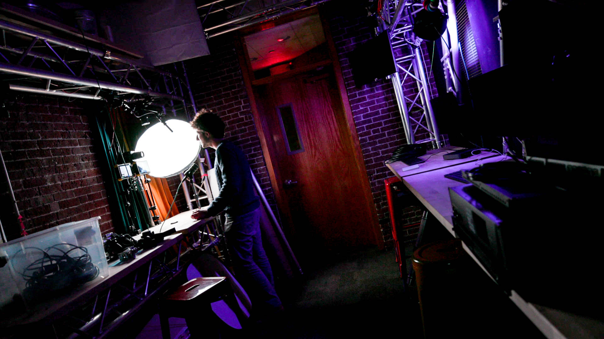 off-kilter behind the scenes shot of Nico presenting