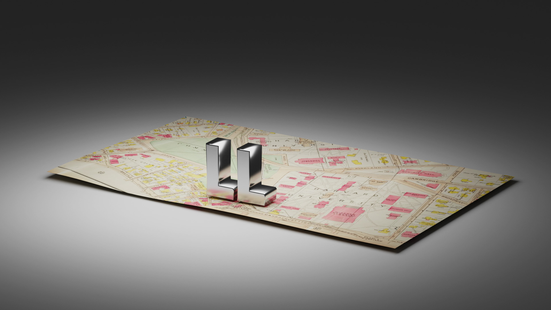 Two silver L's sit on top of a map of Cambridge