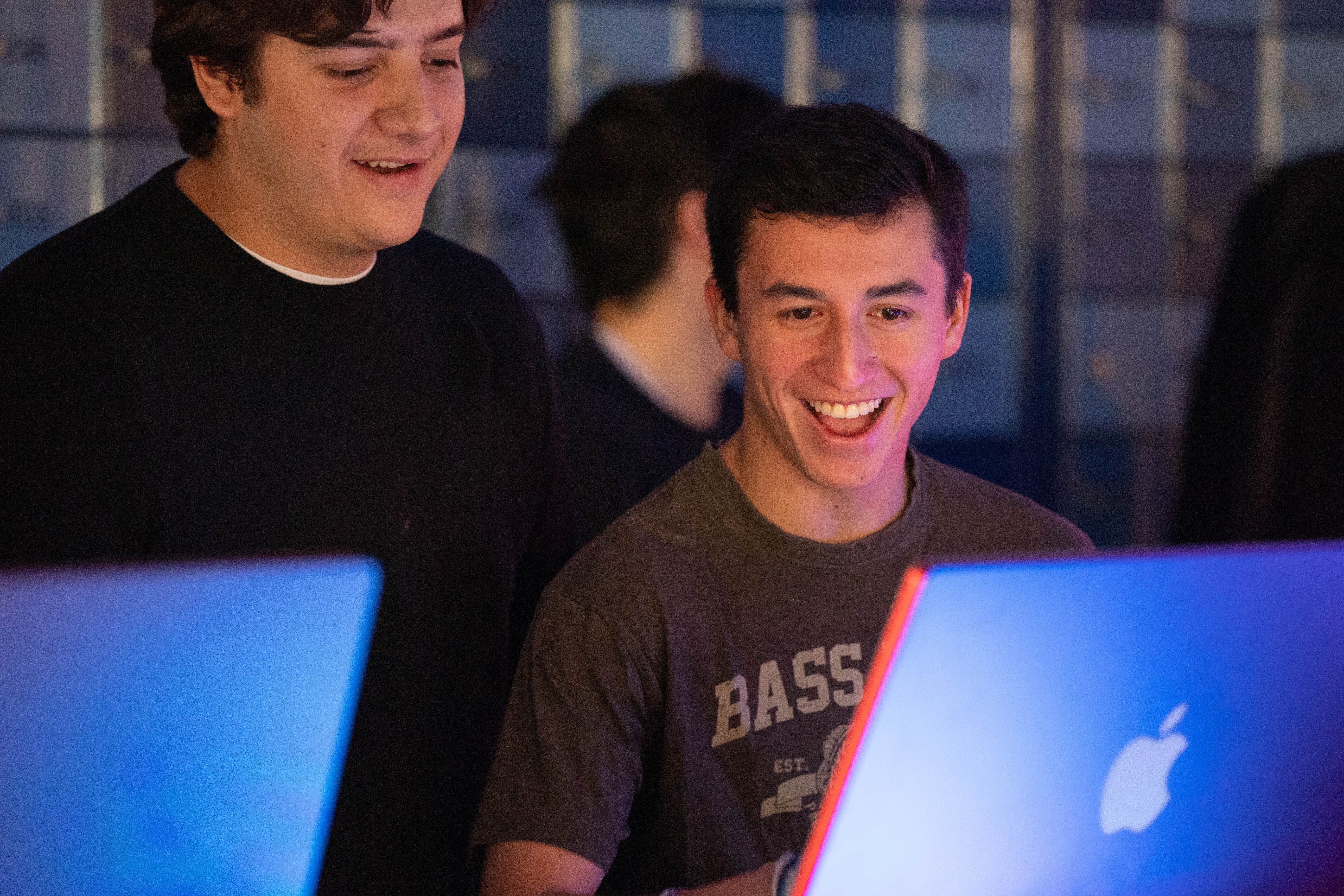 two students looking exuberant as they view their AI-transformed images