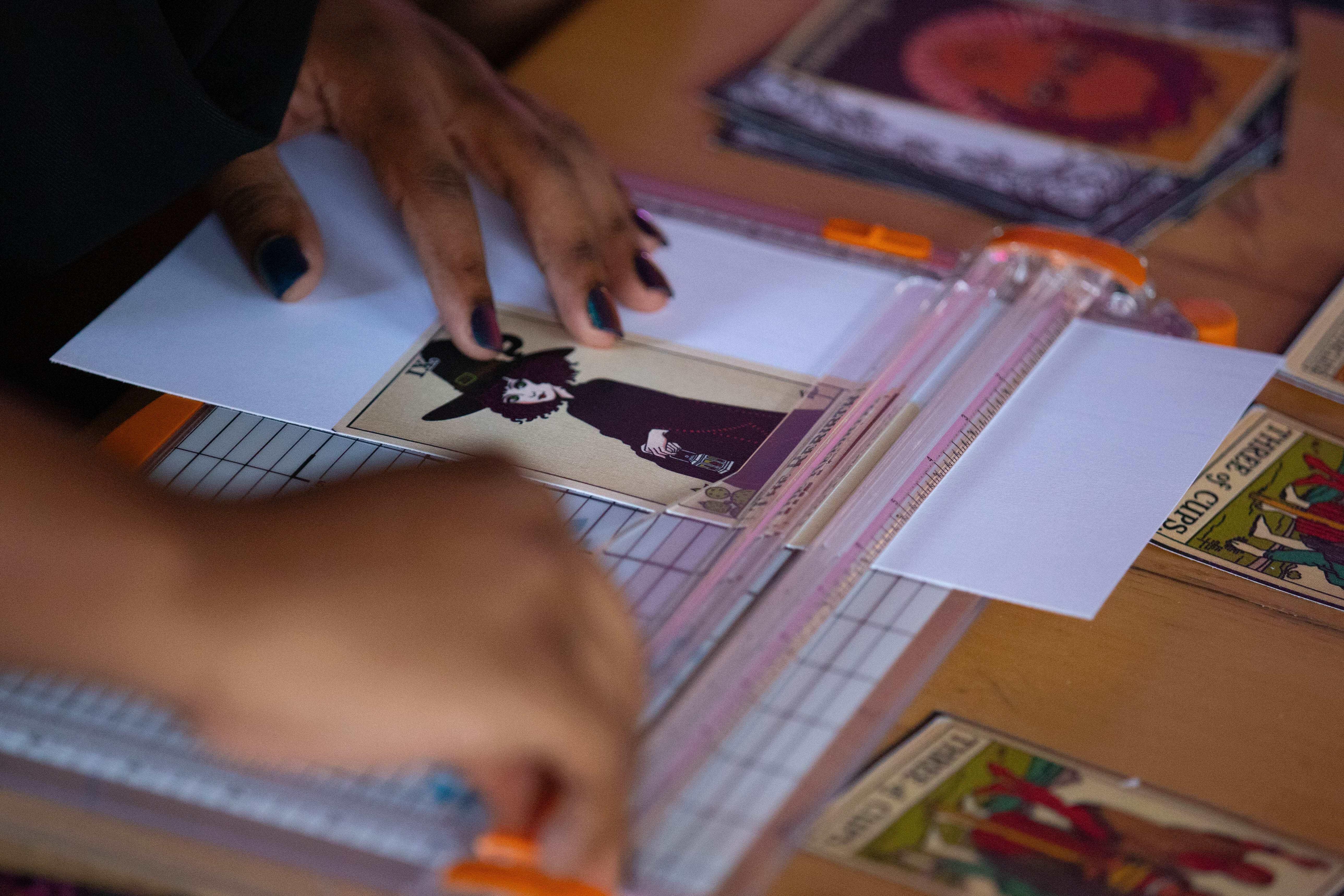a tarot card being cut out after printing